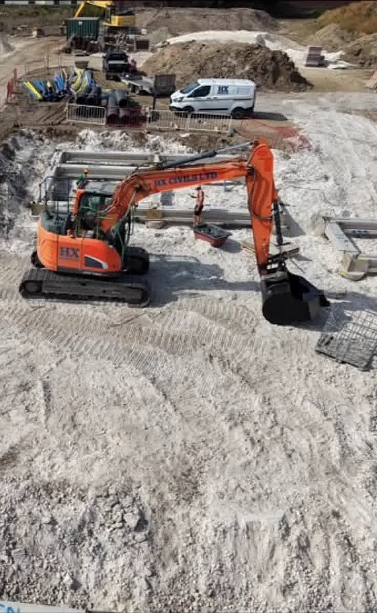 HX Civils excavator fitted with a Sperrin concrete pouring bucket on site